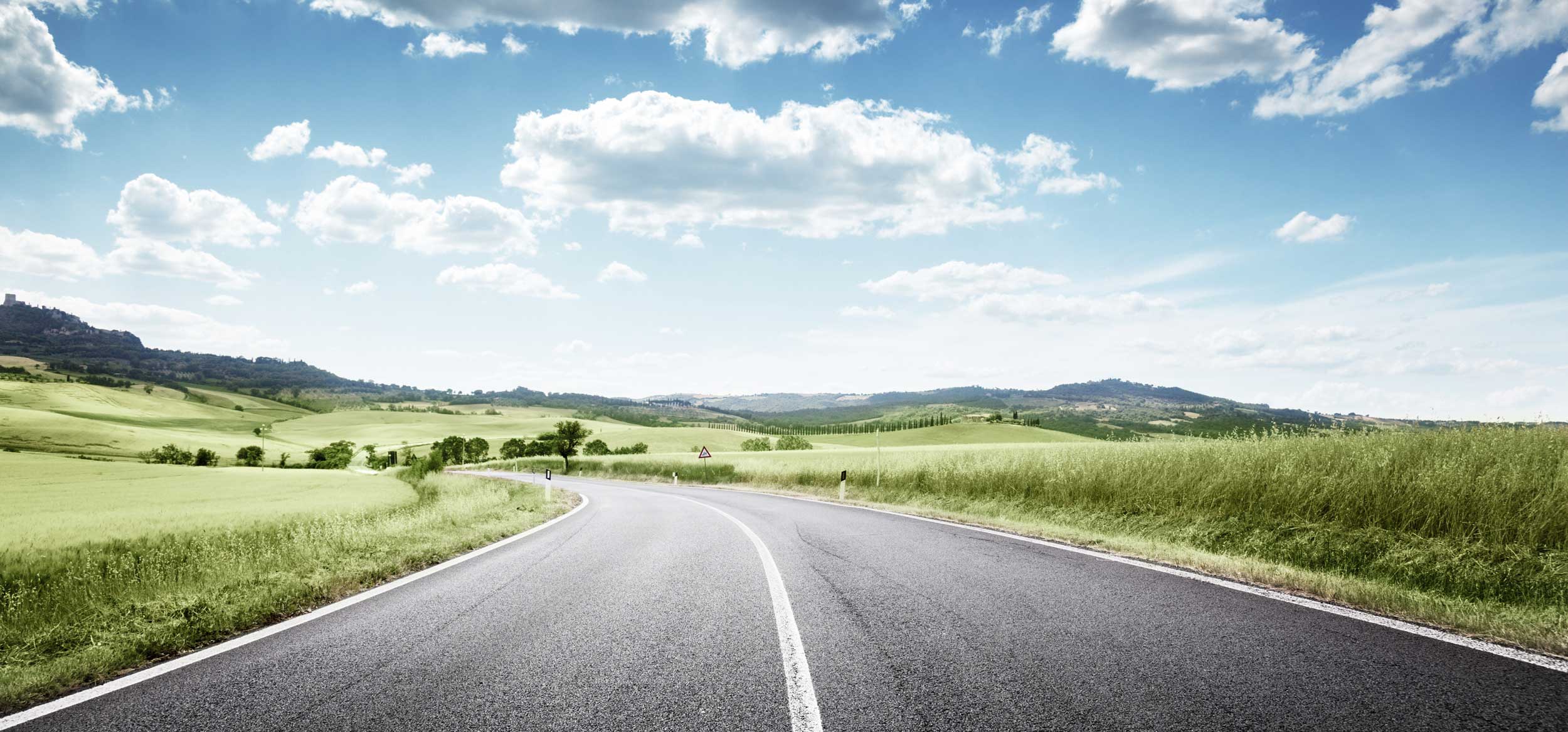 road in a green field